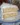 A beautifully frosted Southern Coconut Cake topped with toasted coconut flakes.