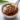 Spicy honey garlic dipping sauce in a small bowl with fresh garlic and honey