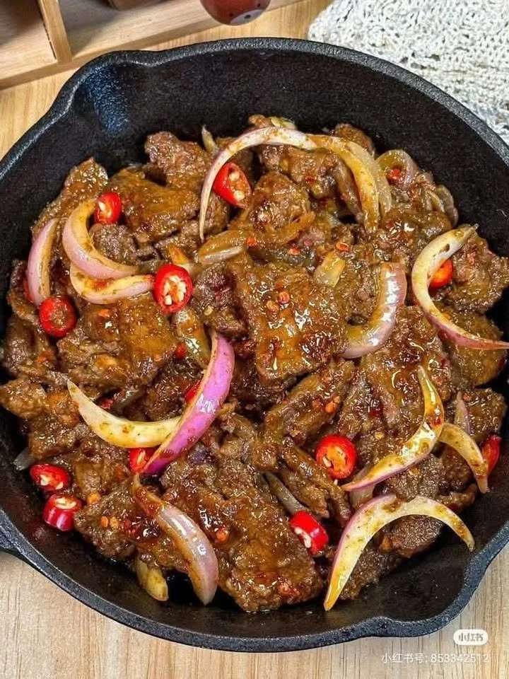Plate of spicy stir-fried beef with onions and chilies