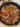 Delicious spicy stir-fried beef with onions and chilies served in a bowl