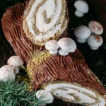 Tiramisu Yule Log Cake decorated with coffee and cocoa powder