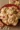 Freshly baked white chocolate cranberry cookies on a cooling rack