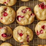 Freshly baked white chocolate cranberry cookies on a plate