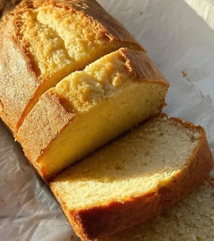 Delicious yogurt loaf cake sliced on a wooden board